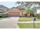 One-story home with attached garage and landscaped yard at 12755 Oulton Cir, Orlando, FL 32832