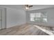 Bright living room with light wood floors and large window at 12755 Oulton Cir, Orlando, FL 32832