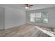 Bright living room with light wood floors and large window at 12755 Oulton Cir, Orlando, FL 32832