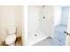 Clean bathroom with toilet and a shower stall at 1827 Wild Rye Way, Kissimmee, FL 34744