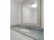 Updated bathroom with granite vanity and large framed mirror at 203 Red Bud Ln, Longwood, FL 32779
