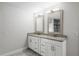 Double vanity bathroom with granite countertops and updated fixtures at 203 Red Bud Ln, Longwood, FL 32779