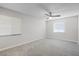 Bright bedroom with grey carpet, ceiling fan and window blinds at 203 Red Bud Ln, Longwood, FL 32779