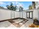 Private courtyard with brick paving, a central stone patio, and lush landscaping at 203 Red Bud Ln, Longwood, FL 32779