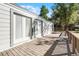 Wooden deck with backyard access and view of trees at 203 Red Bud Ln, Longwood, FL 32779