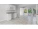Bright kitchen features white shaker cabinets, granite countertops, and view to backyard at 203 Red Bud Ln, Longwood, FL 32779