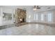 Open living area with a stone fireplace and tiled floors at 203 Red Bud Ln, Longwood, FL 32779