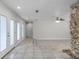 Spacious living room with tile flooring, ceiling fan, and stone accent wall at 203 Red Bud Ln, Longwood, FL 32779