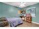 Bedroom with a queen bed, bookshelf, and ceiling fan at 2420 W Park Rd, Deland, FL 32724