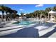 Refreshing pool area with surrounding palm trees at 2564 Grassy Point Dr # 106, Lake Mary, FL 32746