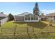 Backyard view of home with a sunroom addition at 3149 Bear Path, Kissimmee, FL 34746