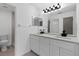 Updated bathroom with double vanity, modern lighting, and a large shower at 3149 Bear Path, Kissimmee, FL 34746