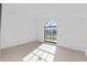 Bright bedroom featuring a large arched window and light flooring at 3149 Bear Path, Kissimmee, FL 34746