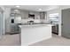 Modern kitchen with a large island and stainless steel appliances at 3149 Bear Path, Kissimmee, FL 34746