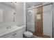 Bathroom with white vanity, toilet and a shower with tile surround at 36 Marigold Ln, Debary, FL 32713