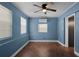 Blue walls, wood-look floors, ceiling fan, and window coverings at 36 Marigold Ln, Debary, FL 32713