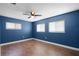 Well-lit bedroom with wood flooring and blue walls at 36 Marigold Ln, Debary, FL 32713