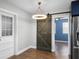 Charming dining area with a rustic barn door and unique light fixture at 36 Marigold Ln, Debary, FL 32713