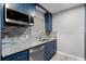 Renovated kitchen with granite countertops and stylish blue cabinets at 36 Marigold Ln, Debary, FL 32713