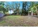 Large backyard with mature trees and a privacy fence at 402 Satsuma Dr, Sanford, FL 32771