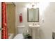 Clean bathroom with pedestal sink, tub, and shower at 402 Satsuma Dr, Sanford, FL 32771