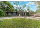 House exterior featuring a ranch style home with a well-manicured lawn and driveway at 402 Satsuma Dr, Sanford, FL 32771