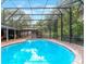 Inviting kidney shaped pool with a screened enclosure in the backyard at 402 Satsuma Dr, Sanford, FL 32771