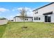 Large backyard with a grassy area and a house at 4932 Mainsail St, Haines City, FL 33844