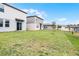 Landscaped backyard with grassy area and houses at 4932 Mainsail St, Haines City, FL 33844