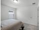 Cozy bedroom featuring a window with blinds and carpet flooring at 4932 Mainsail St, Haines City, FL 33844