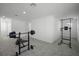 Large home gym with weight bench, barbell, and pull up bar at 4932 Mainsail St, Haines City, FL 33844