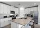 Modern kitchen with white cabinets, granite counters, and stainless steel appliances at 4932 Mainsail St, Haines City, FL 33844