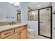 Light bathroom with single vanity and a glass-enclosed shower at 5810 Penney Ln, The Villages, FL 32163