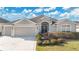 Beautiful one-story home with a two-car garage and manicured landscaping at 5810 Penney Ln, The Villages, FL 32163