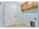 Convenient laundry room with upper cabinets and built-in utilities at 5810 Penney Ln, The Villages, FL 32163