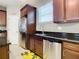 Stainless steel appliances and dark wood cabinets in kitchen at 688 Preakness Cir, Deland, FL 32724