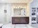 Bright bathroom with dual sinks and a glass-enclosed shower at 16300 County Road 455 # 610, Montverde, FL 34756
