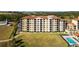 Exterior view of a three-story building with balconies and a pool at 16300 County Road 455 # 610, Montverde, FL 34756