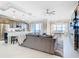 Open concept living room and kitchen with water views, featuring a comfy sectional sofa at 16300 County Road 455 # 610, Montverde, FL 34756