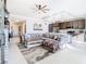 Open concept living area with a large sectional sofa, kitchen, and dining space at 16300 County Road 455 # 610, Montverde, FL 34756