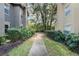 Landscaped walkway between townhome buildings in a quiet community at 213 Villa Di Este Ter # 113, Lake Mary, FL 32746