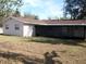 Rear view of a ranch house with screened patio at 2432 E Locke Ave, Orlando, FL 32818