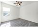 Spacious bedroom featuring a ceiling fan and large window at 3210 Bayflower Ave, Harmony, FL 34773