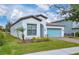 House exterior showcasing front yard landscaping and light teal garage door at 5111 Lazio St, Saint Cloud, FL 34771