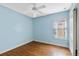 Light blue bedroom with wood floors and ceiling fan at 7614 Acklins Rd, Kissimmee, FL 34747