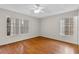 Well-lit bedroom with wood floors and two windows at 7614 Acklins Rd, Kissimmee, FL 34747