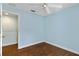 Light blue bedroom with wood floors and ceiling fan at 7614 Acklins Rd, Kissimmee, FL 34747