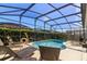 Relaxing screened-in pool with lounge chairs and plenty of sun at 8119 Fan Palm Way, Kissimmee, FL 34747