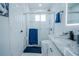 Modern bathroom with white cabinets, granite countertop, and walk-in shower at 2214 Wyndham Palms Way, Kissimmee, FL 34747
