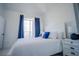 Bright bedroom with white furniture, blue accents, and a large window at 2214 Wyndham Palms Way, Kissimmee, FL 34747